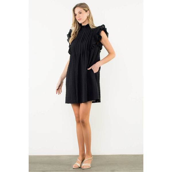 Woman wearing a black dress on a white background