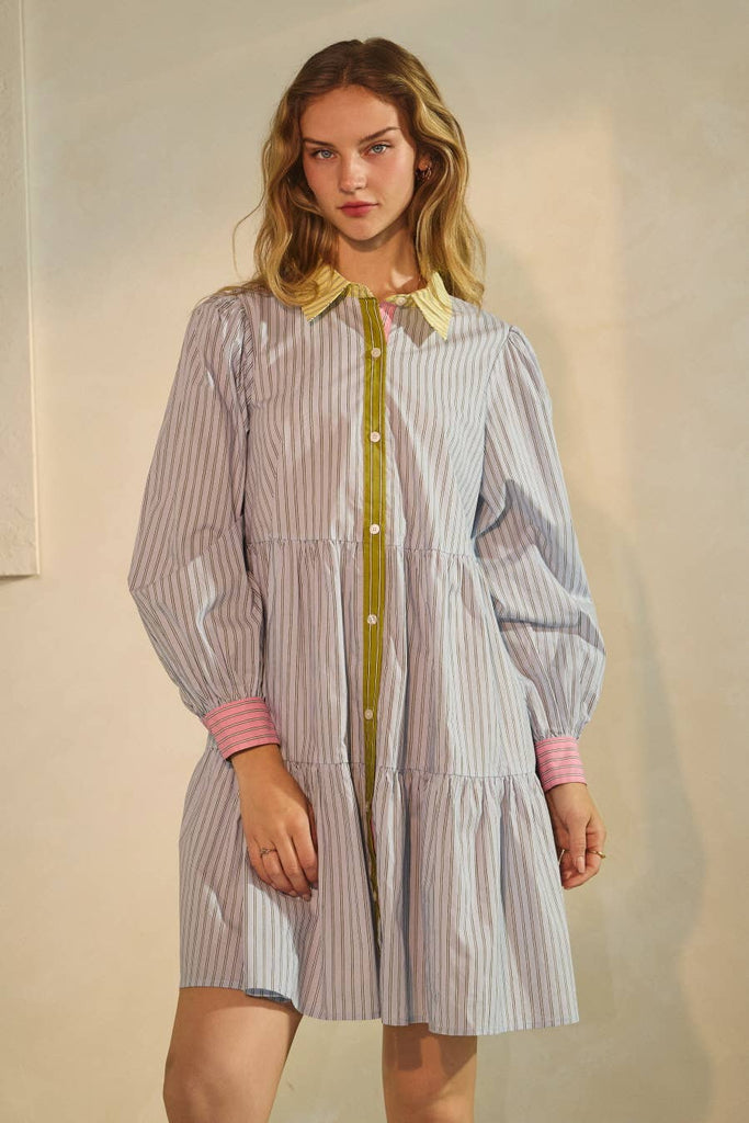 Woman wearing a striped dress with a plain background