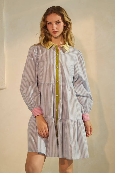 Woman wearing a striped dress with a plain background