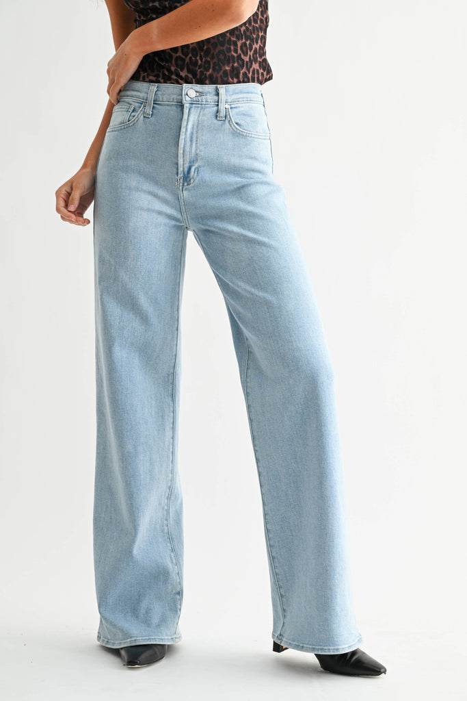 Light blue jeans worn by a person on a white background