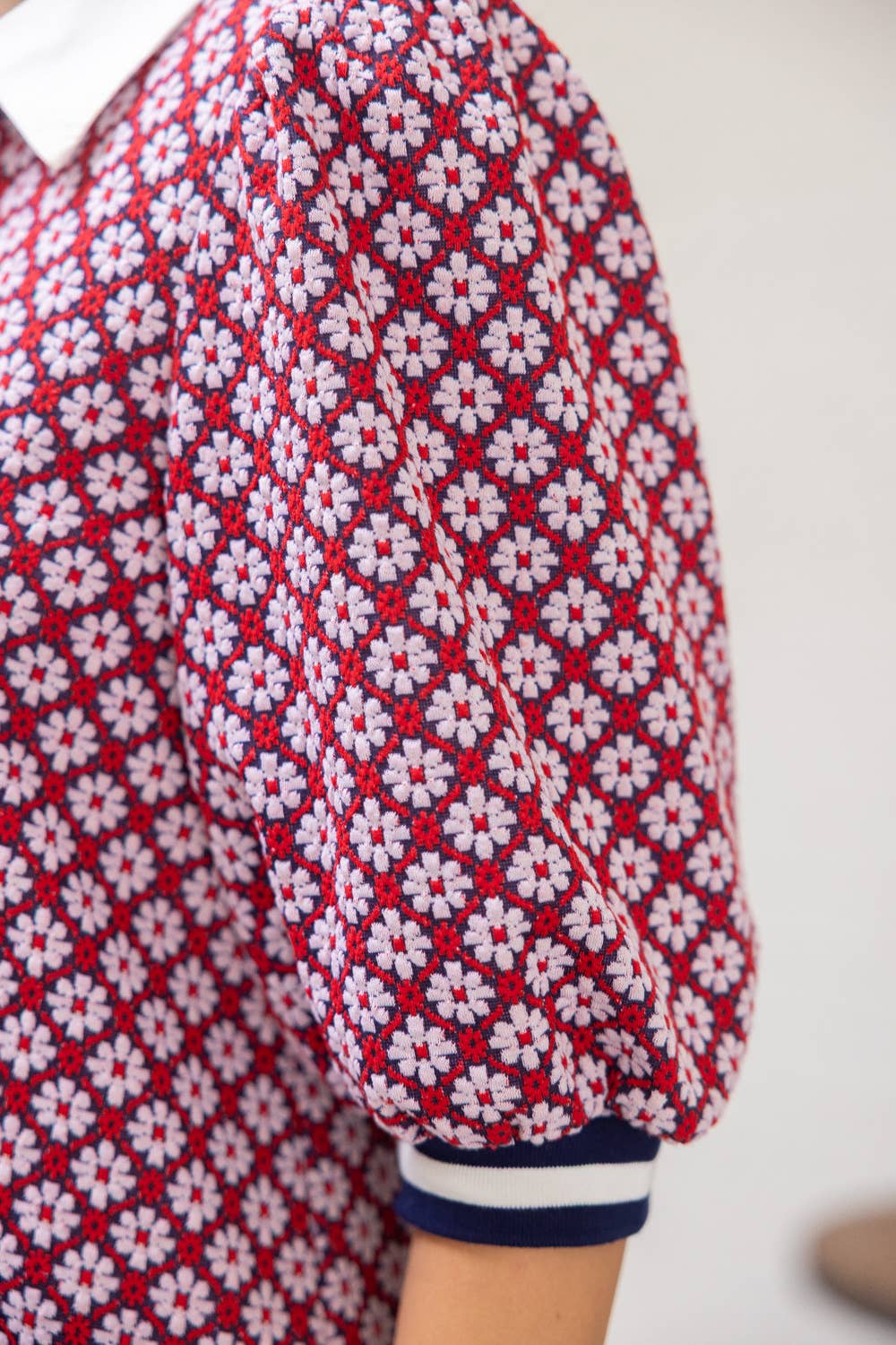 Close-up of a red and white patterned shirt with a plain background