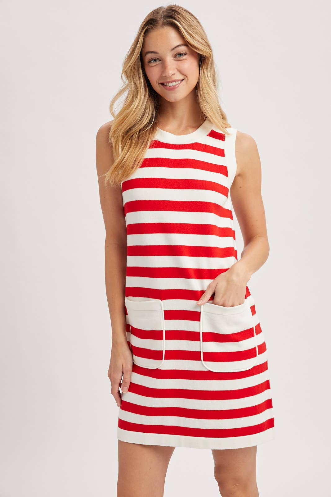 Woman wearing a red and white striped dress on a plain background showing front view