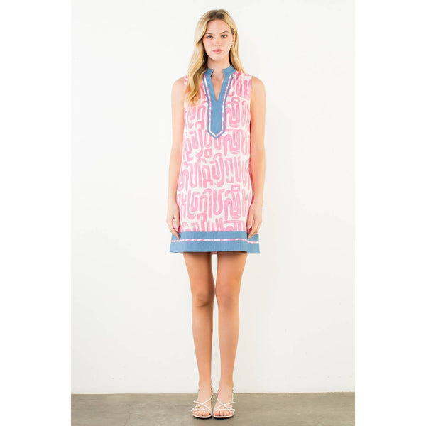 Woman wearing a sleeveless dress with a pattern on a white background showing front view.