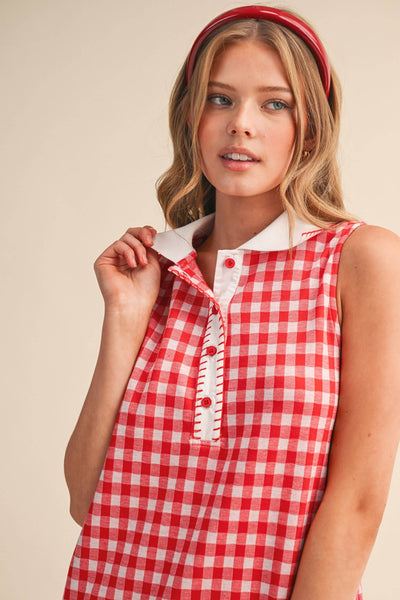 Woman wearing a red and white checkered dress with a plain background