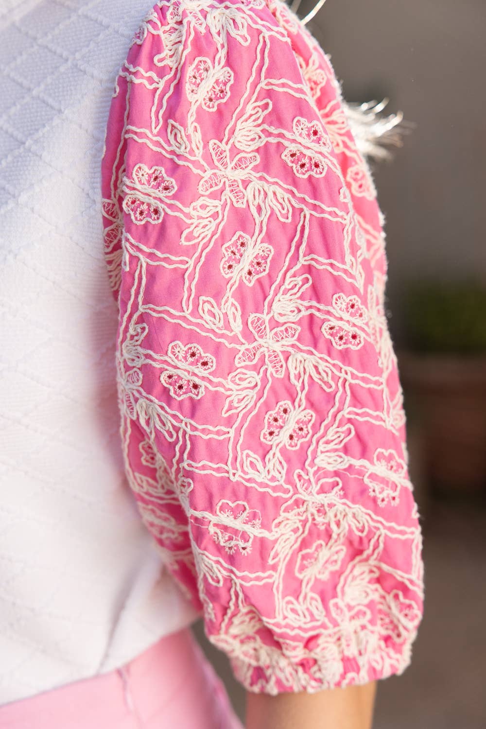 Close-up of a pink garment with white floral pattern